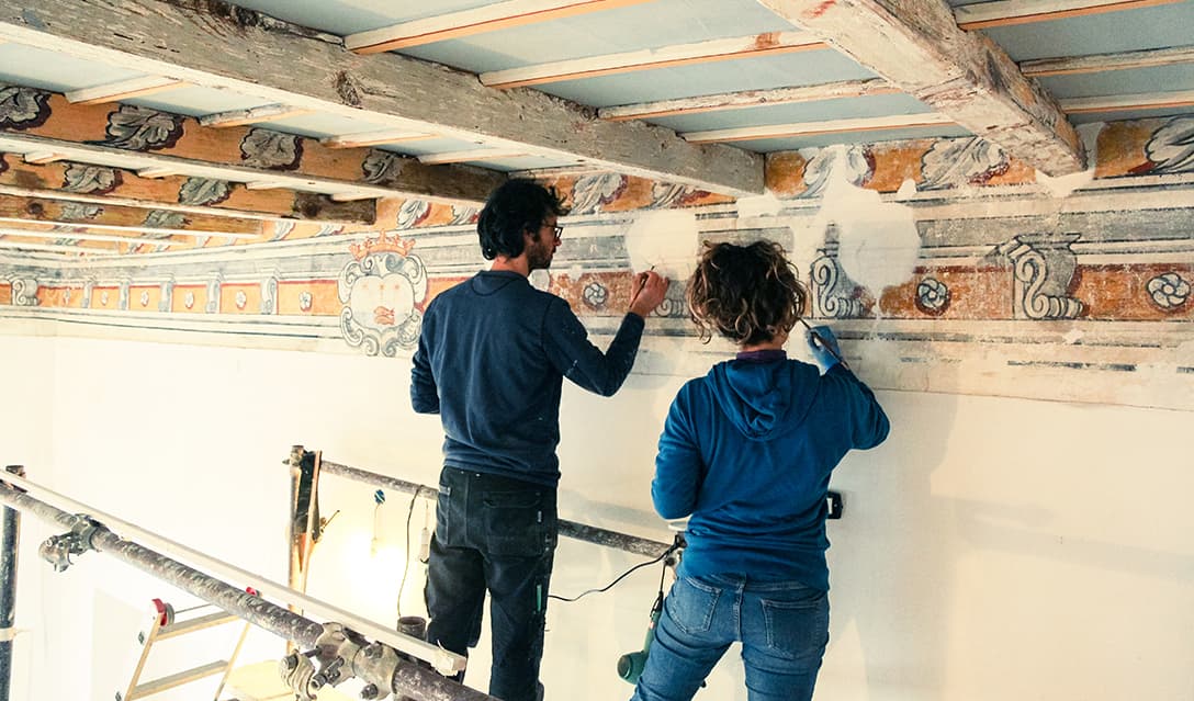 The two restorers working on the frescoed ceiling